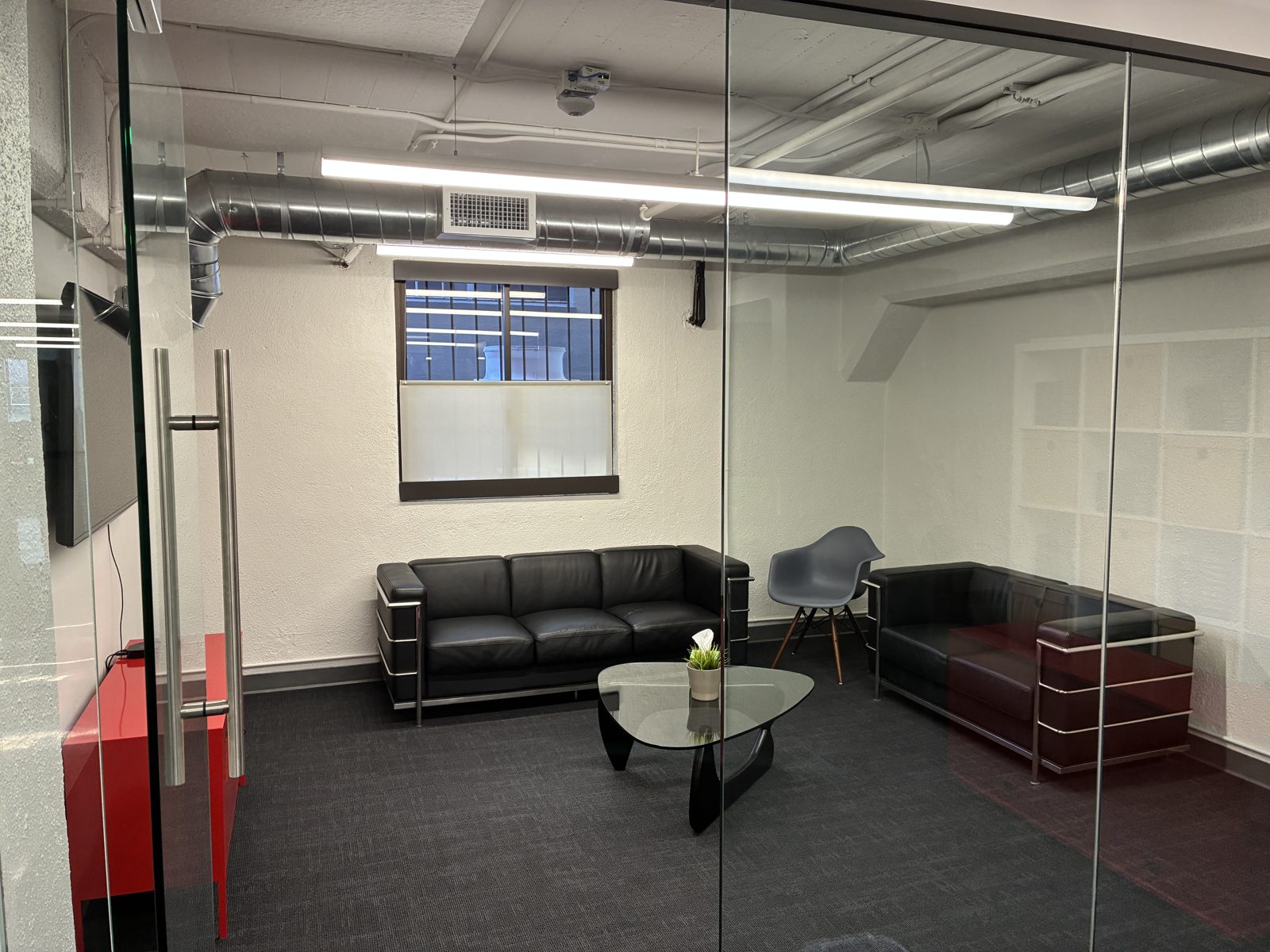 A glass meeting room for pitches, interviews, and 1:1s.